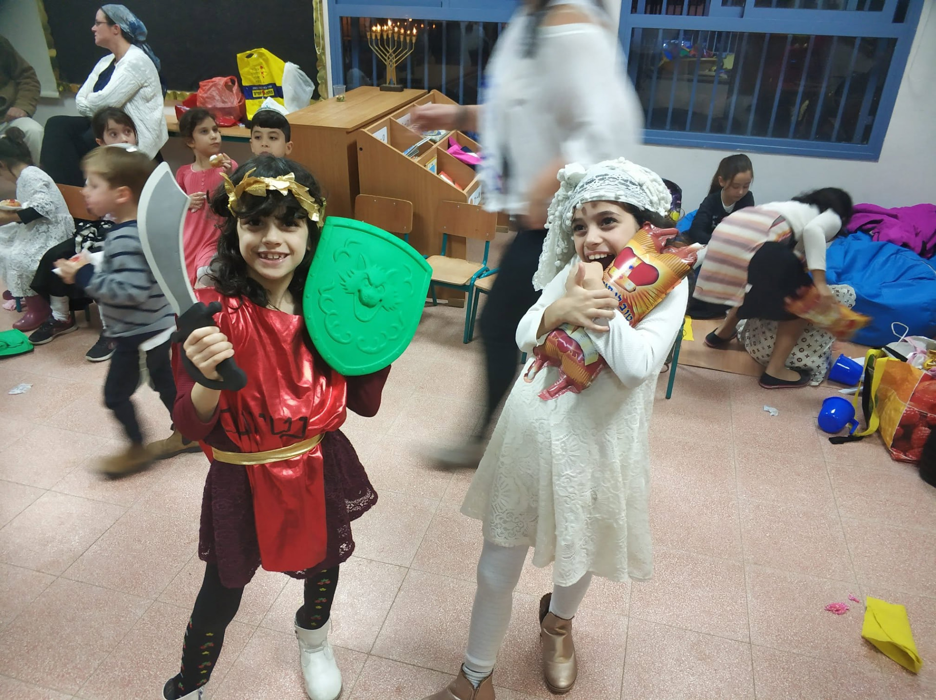 Children in festive costumes smiling at a community holiday gathering
